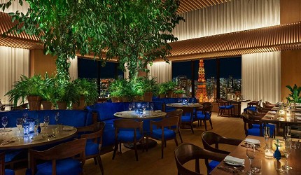 東京エディション虎ノ門飯店的高級餐廳內部，設有藍色調的現代化用餐空間，配備舒適的座椅和優雅的室內設計