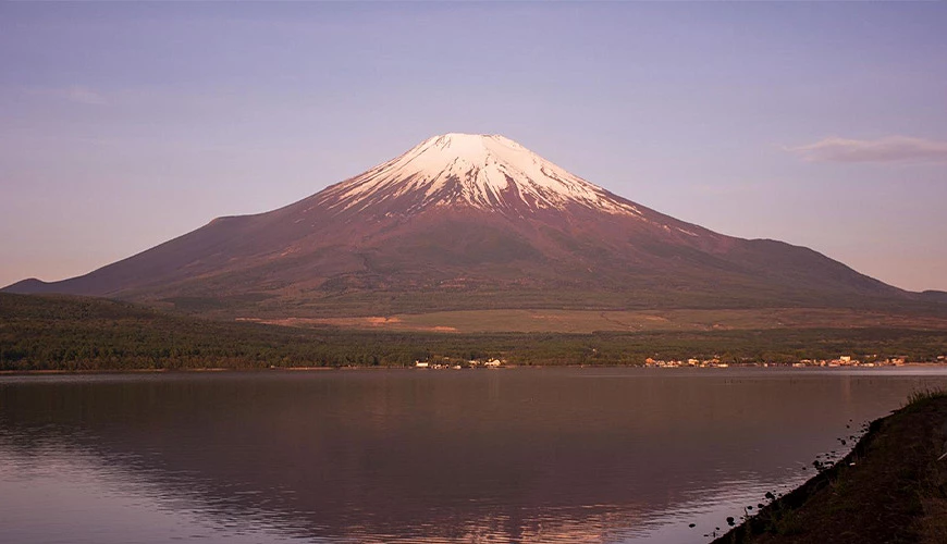 河口湖畔遠望富士山景色,湖面映出山形倒影,天色柔和