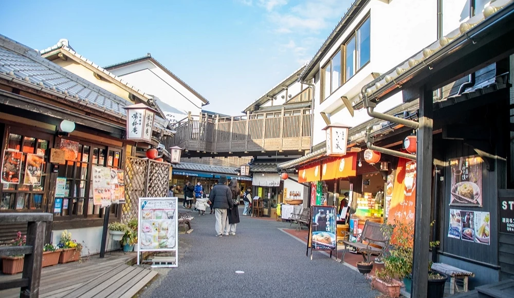 老街木造店鋪並排,燈籠懸掛天橋橫跨其上