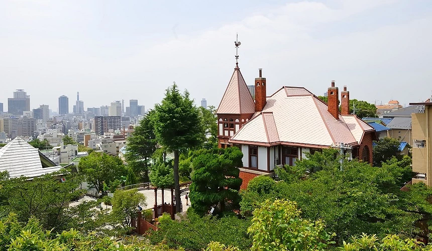 在復古西洋建築的後方是神戶的現代城市景致