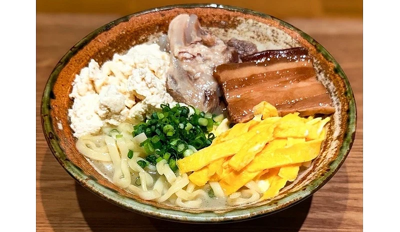 上面撲滿蛋絲肉塊及蔥花的一碗拉麵