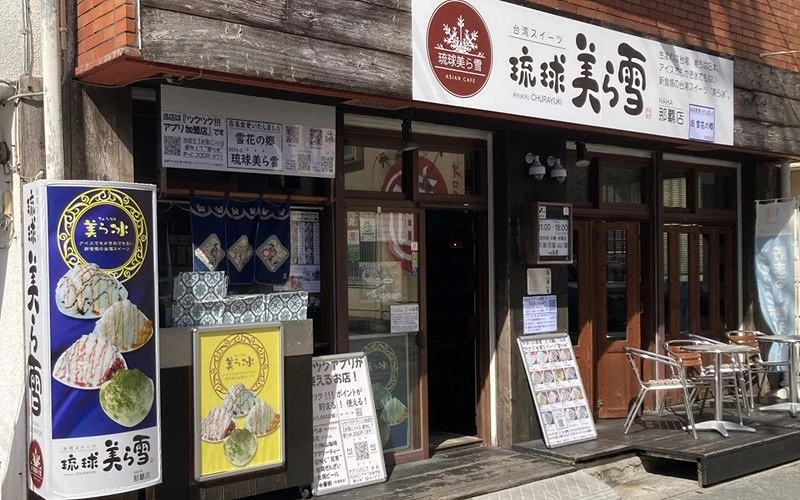 店面外觀掛有「琉球美ら雪」招牌，門口擺放刨冰圖片廣告與戶外桌椅
