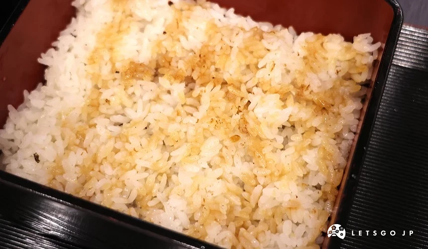 餐盒內盛裝淋有醬汁的白飯