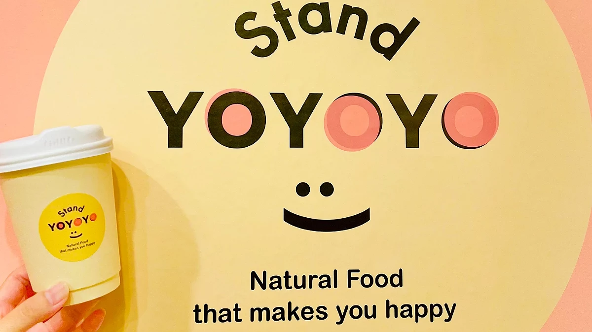 Stand YOYOYO 的圓形黃色 Logo與熱飲