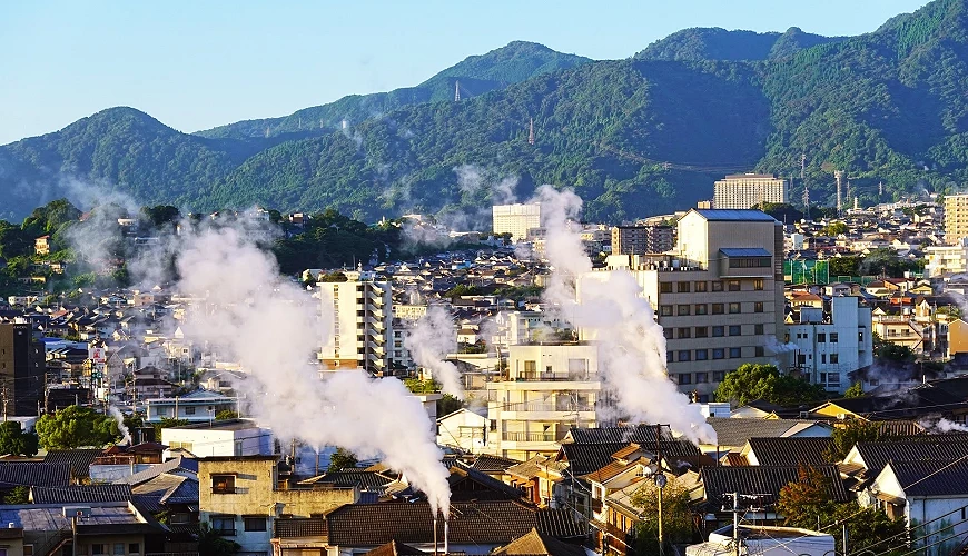 被山巒圍繞的別府温泉鄉,街道霧氣裊裊的景象