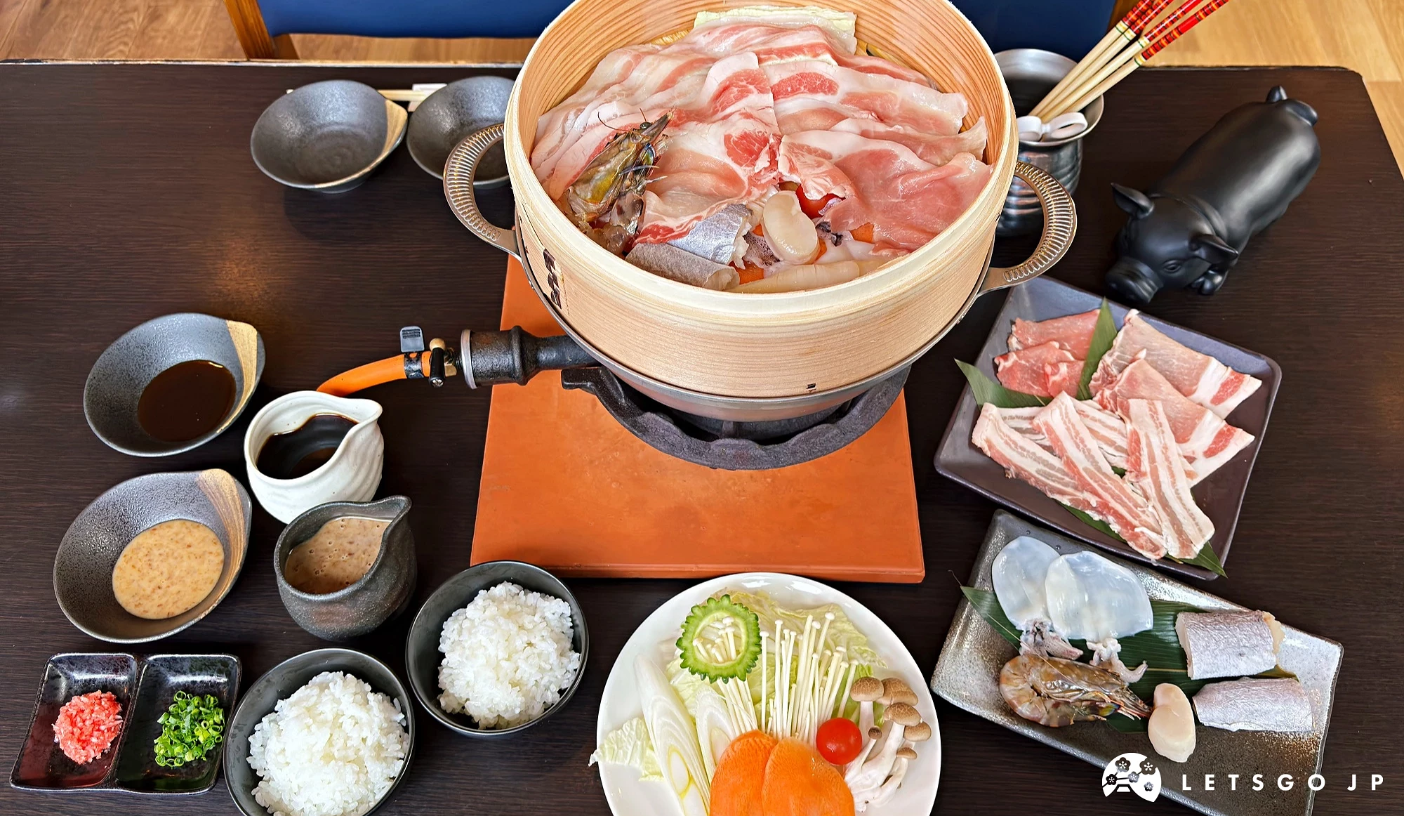 阿古豬隱家萬座店的阿古豬與海鮮蒸籠套餐,搭配白飯、蔬菜與醬料