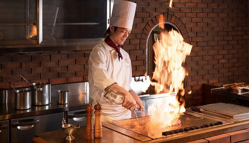 主廚在鐵板燒台前料理牛排時燃起烈焰提供:Restaurant Tiffany
