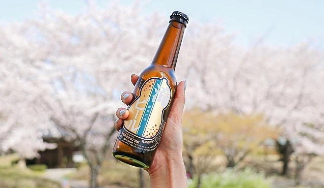 手上拿著一瓶啤酒