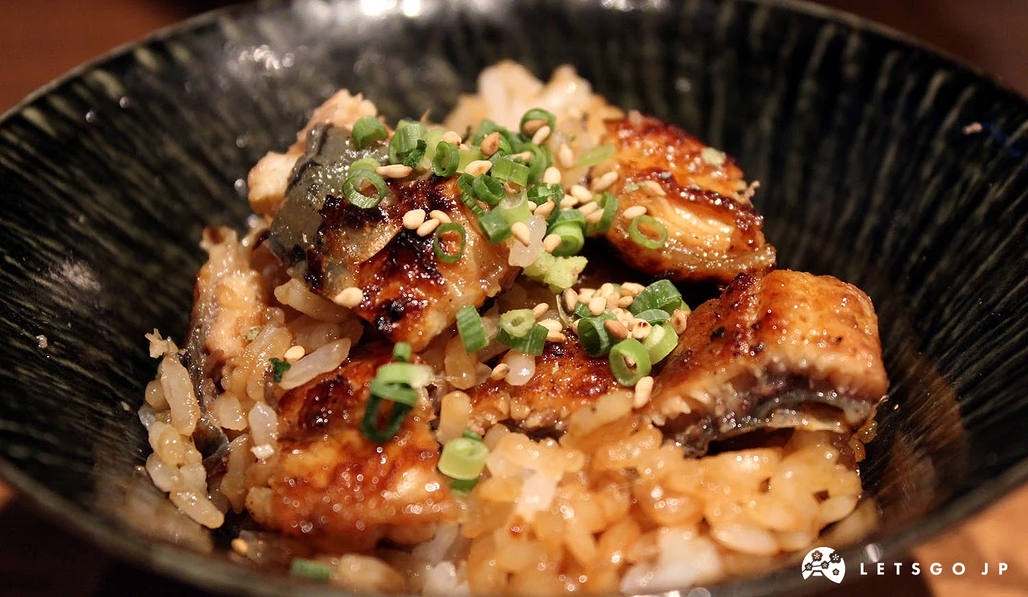加入藥味(蔥花、芝麻、山葵)的鰻魚飯。