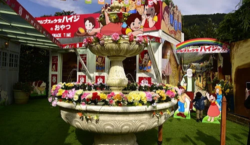 庭園噴水池裝飾鮮花,背景卡通彩繪牆面